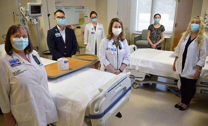 Group of Doctors and Nurses in Hospital Room