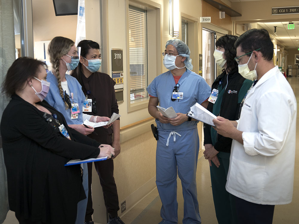 Group of Doctors and Nurses in circle having a disucussion