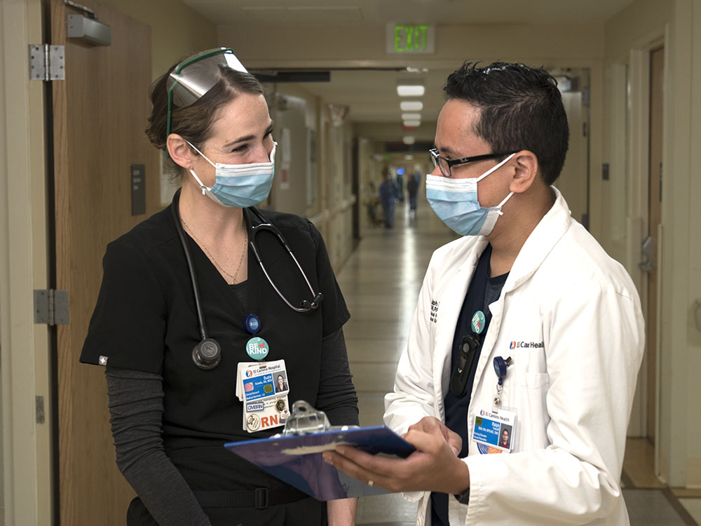 Woman Nurse collaborating with male Doctor