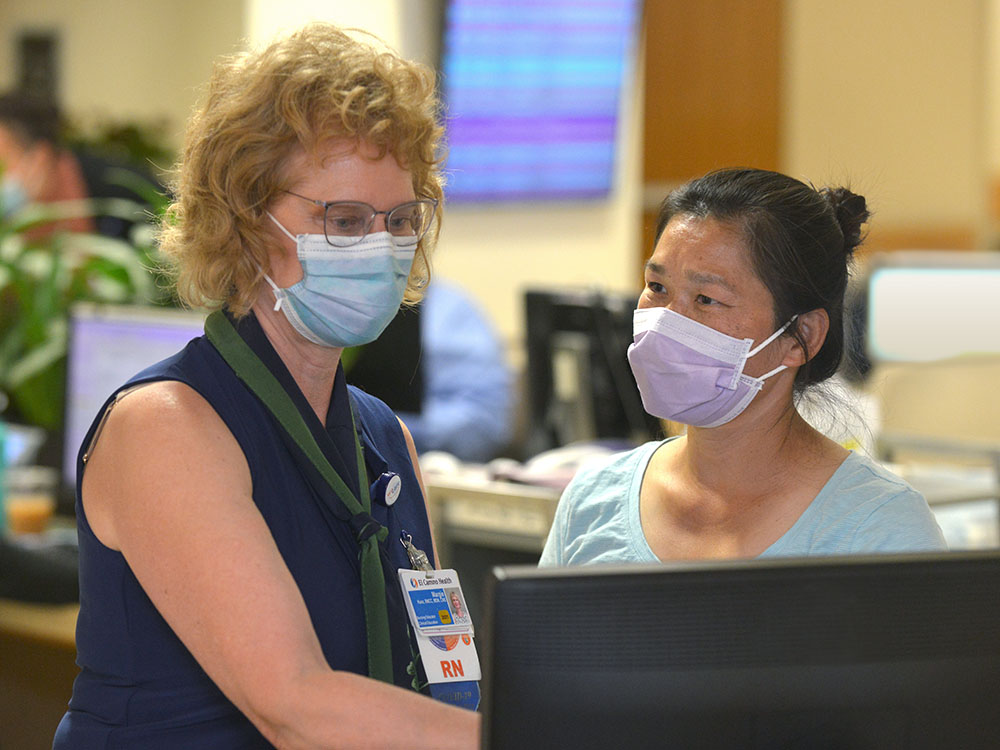 Woman Nurse collaborating with another woman 