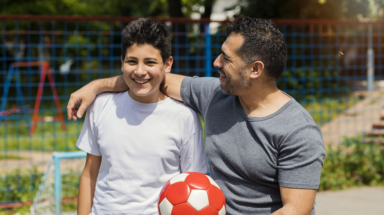 Latino Father and Son with Soccer Ball