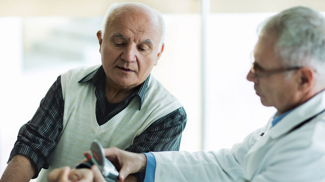 Doctor examining older gentleman