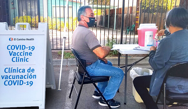 Man getting Covide-19 Vaccine at outdoor clinic