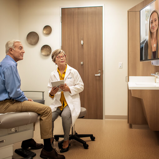 Physicians consulting with patient leveraging video conferencing.