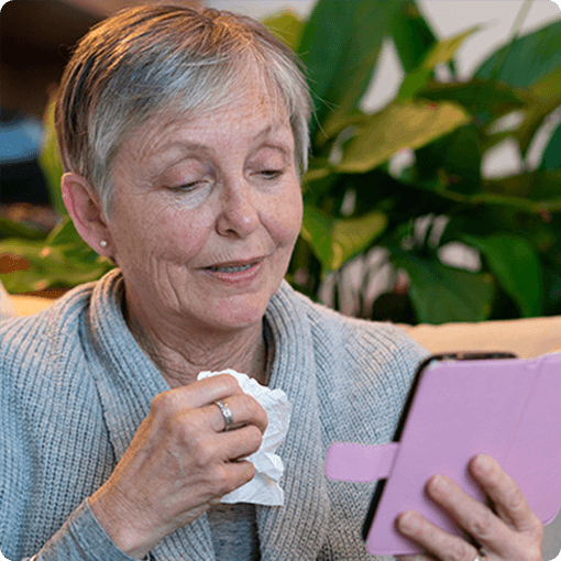 Ill woman consulting with an El Camino Health physician via smartphone.