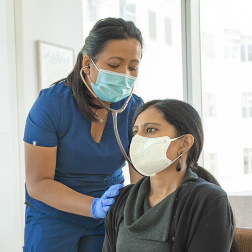 El Camino Health physician checking a patient's breathing.