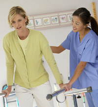 female nurse helping woman walk